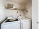 Bright laundry room with washer, dryer, and shelving at 1469 Swan Pl, Kissimmee, FL 34759