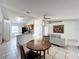 Open living room and kitchen with light tile floors at 1469 Swan Pl, Kissimmee, FL 34759