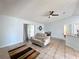 Cozy living room with neutral tones, modern ceiling fan, and sliding door access at 1469 Swan Pl, Kissimmee, FL 34759