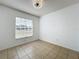 Spacious bedroom with tile floors and large window at 1469 Swan Pl, Kissimmee, FL 34759