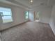 Spacious bedroom with neutral carpeting, tray ceiling, and two large windows allowing natural light at 1664 Andover Ridge Dr, Deland, FL 32720