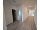 Long hallway with tile flooring that connects the living spaces and bedrooms in the home at 1664 Andover Ridge Dr, Deland, FL 32720