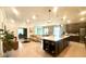 A spacious kitchen with a large island, pendant lighting, and seamless flow into the living and dining areas at 1664 Andover Ridge Dr, Deland, FL 32720