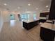 Open-concept living area with tile floors, large kitchen island, and plenty of natural light at 1664 Andover Ridge Dr, Deland, FL 32720