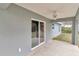 Covered patio with sliding glass doors leading to backyard at 199 Juniper Way, Ocala, FL 34472