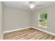 Spacious bedroom with a window and wood-look floors at 199 Juniper Way, Ocala, FL 34472