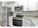 Modern kitchen with stainless steel appliances and granite countertops at 199 Juniper Way, Ocala, FL 34472