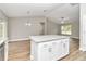Kitchen island with granite countertops and white cabinets at 199 Juniper Way, Ocala, FL 34472
