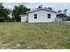 View of backyard with the home's exterior in background on a sunny day at 2302 E Dana Dr, Deltona, FL 32738