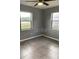 Bright bedroom filled with natural light from two windows, finished with tile flooring at 2302 E Dana Dr, Deltona, FL 32738