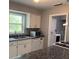 Well-lit kitchen features stainless steel appliances, granite countertops, and ample storage at 2302 E Dana Dr, Deltona, FL 32738