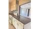 Functional kitchen boasts granite countertops, and white cabinetry at 2302 E Dana Dr, Deltona, FL 32738