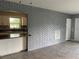 Inviting living room seamlessly connects to the kitchen, highlighted by a grey brick wall at 2302 E Dana Dr, Deltona, FL 32738