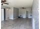 Spacious living room featuring neutral paint, ceiling fans and tile flooring at 2302 E Dana Dr, Deltona, FL 32738