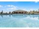 Relaxing community pool, with shallow water and a clubhouse in background, makes for perfect vacationing at 3243 Arch Ave, Ormond Beach, FL 32174