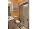 Bathroom with a standard white toilet, vanity, medicine cabinet, and shower with sliding glass doors at 11 Sandra Cir, New Smyrna Beach, FL 32168
