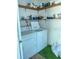 Laundry room with a washer, dryer, and shelving for storage, set up to maximize space at 11 Sandra Cir, New Smyrna Beach, FL 32168