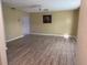 Spacious living room with updated flooring and a ceiling fan offering comfort and style at 11 Sandra Cir, New Smyrna Beach, FL 32168