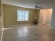 Inviting living room featuring a bright window, neutral paint, and a modern ceiling fan at 11 Sandra Cir, New Smyrna Beach, FL 32168