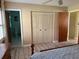 Bedroom with a ceiling fan, large closet, and an ensuite bathroom with tile floors at 11 Sandra Cir, New Smyrna Beach, FL 32168
