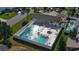Aerial view of community pool, hot tub, and lounging area with lush landscaping at 11 Sandra Cir, New Smyrna Beach, FL 32168