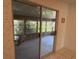 View of the enclosed porch, accessed through sliding glass doors from the kitchen, with an outdoor dining set at 11 Sandra Cir, New Smyrna Beach, FL 32168