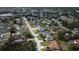 Aerial view of a neighborhood featuring homes, streets, lakes, and lush greenery on a sunny day at 3258 Cranston St, Deltona, FL 32738
