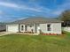 Inviting single-story home with lush lawn, fresh landscaping, gray roof, and a convenient two-car garage at 3258 Cranston St, Deltona, FL 32738