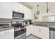 Modern kitchen with white cabinets and stainless steel appliances at 3780 Plainview Dr, Orlando, FL 32824