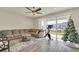 Living room with large sectional sofa and sliding glass doors to patio at 3780 Plainview Dr, Orlando, FL 32824