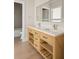 Modern bathroom with double vanity and a large mirror at 531 Sanctuary Golf Pl, Apopka, FL 32712
