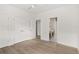 Spacious bedroom with wood-look floors and access to bathroom at 531 Sanctuary Golf Pl, Apopka, FL 32712