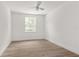 Bright bedroom with wood-look floors and ceiling fan at 531 Sanctuary Golf Pl, Apopka, FL 32712