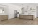 Modern kitchen with white cabinets, light wood island, and stainless steel appliances at 531 Sanctuary Golf Pl, Apopka, FL 32712