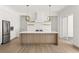 Modern kitchen with white cabinets, light wood island, and stainless steel appliances at 531 Sanctuary Golf Pl, Apopka, FL 32712