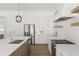 Modern kitchen with white cabinets, stainless steel appliances and light wood island at 531 Sanctuary Golf Pl, Apopka, FL 32712