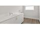 Clean laundry room with white cabinets and sink at 531 Sanctuary Golf Pl, Apopka, FL 32712