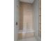 Spa-like shower with wood-like tile and bench at 531 Sanctuary Golf Pl, Apopka, FL 32712