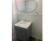 Stylish bathroom featuring a vanity with a marble countertop, a modern mirror, and neutral decor at 766 Carlson Dr, Orlando, FL 32804