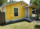 Charming yellow home with a small front porch, offering a welcoming entrance and curb appeal at 766 Carlson Dr, Orlando, FL 32804