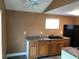 Functional kitchen boasts ample counter space, wood cabinets, and black appliances at 766 Carlson Dr, Orlando, FL 32804