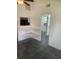Living area with tiled floors, corner shelves, and mirrored doors, blending style with practical features at 766 Carlson Dr, Orlando, FL 32804