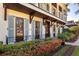 Two-story home with light-colored facade, blue shutters, and landscaped yard at 1400 Place Picardy, Winter Park, FL 32789