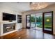 Gathering room with fireplace, built-ins, and sliding doors to the pool at 1400 Place Picardy, Winter Park, FL 32789