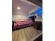 Small bedroom featuring a bed, nightstand, and vinyl floors at 5165 Gwynne Ave, Orlando, FL 32810