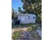 Exterior of small home with overgrown yard at 5165 Gwynne Ave, Orlando, FL 32810