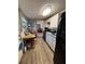 Compact kitchen featuring black appliances, white cabinets, and vinyl floors at 5165 Gwynne Ave, Orlando, FL 32810