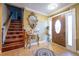 Inviting entryway with a grand wooden door and ornate mirror at 610 Alton Rd, Winter Springs, FL 32708