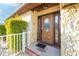 Brown wooden front door with etched glass and a welcome mat at 610 Alton Rd, Winter Springs, FL 32708