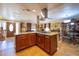 Open kitchen island with granite countertops and wood cabinets at 610 Alton Rd, Winter Springs, FL 32708